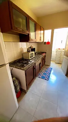 a kitchen with a stove and a microwave at 2B Flat City Center Marrakech in Marrakech