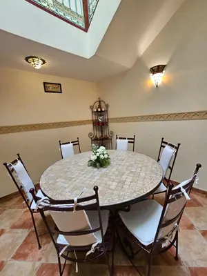 a dining room with a table and chairs at Mira Medina Garden in Marrakech