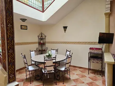 a dining room with a table and chairs at Mira Medina Garden in Marrakech