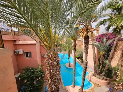 an overhead view of a swimming pool with palm trees at Mira Medina Garden in Marrakech