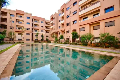 a swimming pool in front of a building at apart in the centre of marrakech gueliz in Marrakech