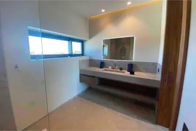 a bathroom with a sink and a mirror at Magnifique villa sur front de golf Amelkis in Marrakech