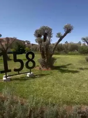 a sign in the middle of a field at Magnifique villa sur front de golf Amelkis in Marrakech