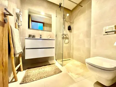 a bathroom with a shower and a toilet and a sink at Noria cosy & chic jardin privé in Marrakech