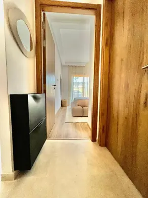 a hallway with a couch in a house at Noria cosy & chic jardin privé in Marrakech