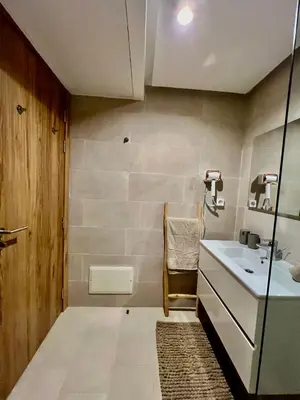 a bathroom with a sink and a mirror at Noria cosy & chic jardin privé in Marrakech