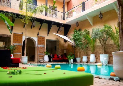 a pool in the middle of a building with a pool table at Riad Romance in Marrakech