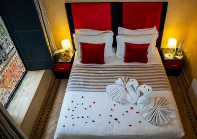 a bedroom with a bed with two swans on it at Riad Romance in Marrakech