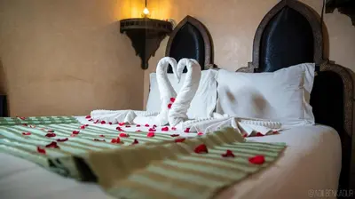 two swans made out of hearts sitting on a bed at Riad Romance in Marrakech