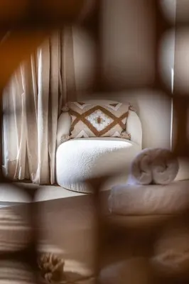 a close up of a white bed with a blanket at Villa 150 Amelkis 2-piscine chauffée in Marrakech