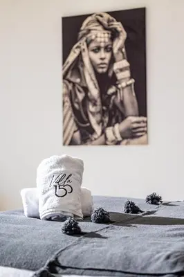 a bed with a pillow with the word on it at Villa 150 Amelkis 2-piscine chauffée in Marrakech