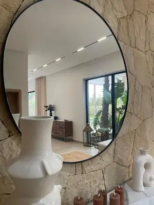 a room with a mirror and vases on display at Villa 150 Amelkis 2-piscine chauffée in Marrakech