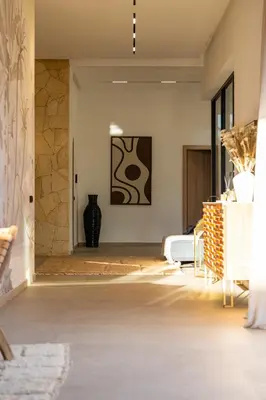 a living room with a bed and a table at Villa 150 Amelkis 2-piscine chauffée in Marrakech