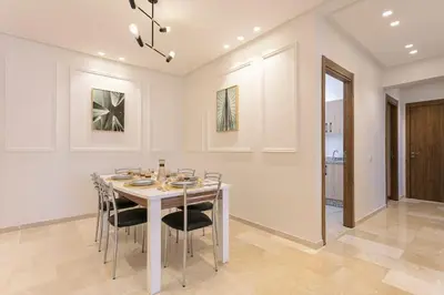 a dining room with a table and chairs at Feel At Home Heart Of Marrakech in Marrakech
