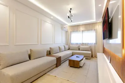 a living room with a couch and a tv at Feel At Home Heart Of Marrakech in Marrakech