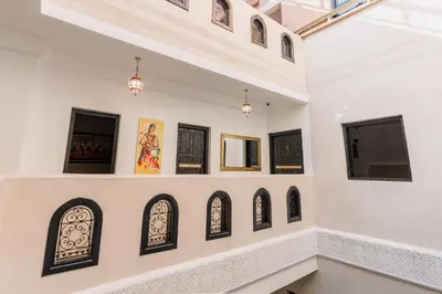 a room with a bunch of art on the wall at Riad Cologne in Marrakech