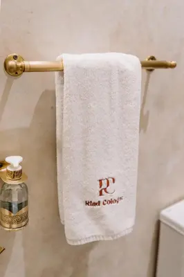 a towel hanging on a towel rack in a bathroom at Riad Cologne in Marrakech