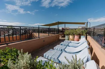 a row of pillows sitting on top of a balcony at Riad Cologne in Marrakech
