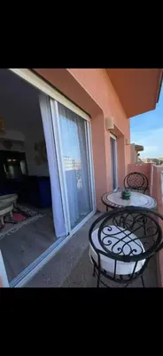 a balcony with two iron tables and a large window at Dreamy Majorelle and Bohemian Majorelle in Marrakech