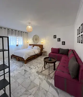 a living room with a couch and a bed at Dreamy Majorelle and Bohemian Majorelle in Marrakech