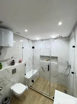 a white bathroom with a shower and a toilet at Dreamy Majorelle and Bohemian Majorelle in Marrakech