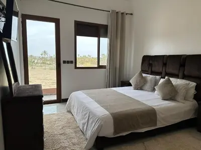 a bedroom with a large bed and a window at Full Moon APPARTS in Marrakech