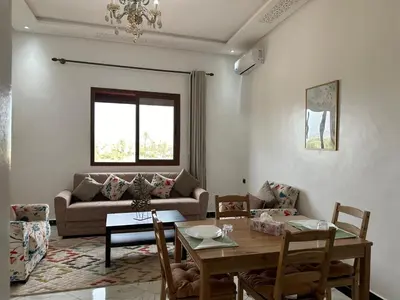 a living room with a table and a couch at Full Moon APPARTS in Marrakech
