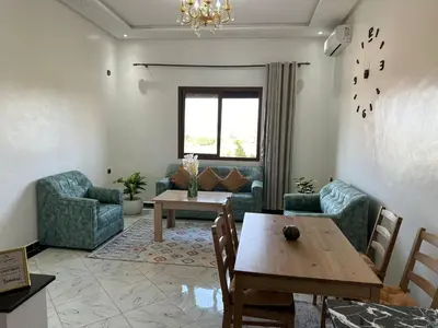 a living room with a table and chairs and a couch at Full Moon APPARTS in Marrakech