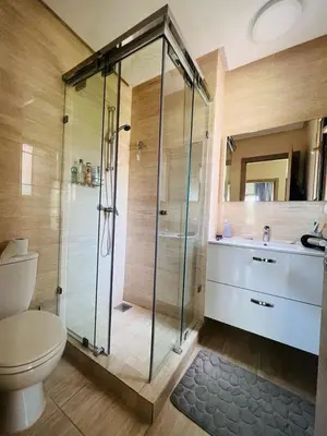 a bathroom with a shower and a toilet and a sink at Luxueux Prestigia golf city Marrakech in Marrakech