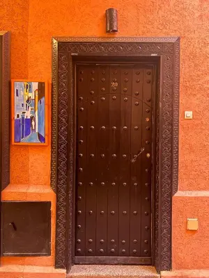 a black door on the side of a building at Riad NYAH in Marrakech