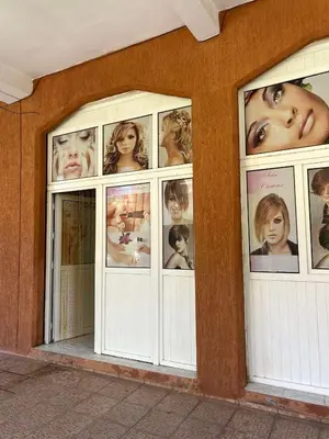 a group of windows with pictures of people at Riad NYAH in Marrakech