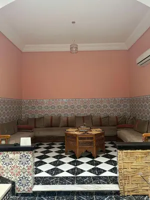a living room with a couch and a table at Riad NYAH in Marrakech