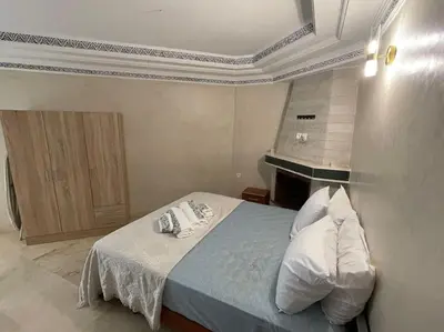 a bedroom with a bed with pillows on it at Confort et Style Studio Chic avec Piscine in Marrakech