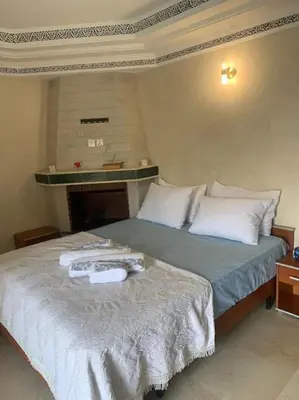 a bedroom with a bed with towels on it at Confort et Style Studio Chic avec Piscine in Marrakech