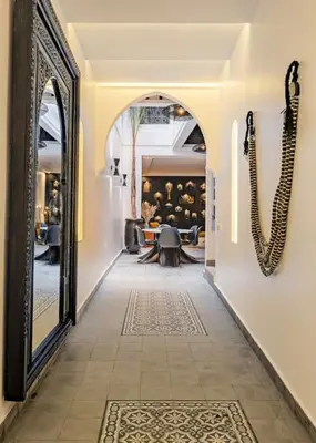 a hallway with a mirror and a table in a room at Riad SASHA Exclusive&New Pool 6 pax Free Breakfast in Marrakech