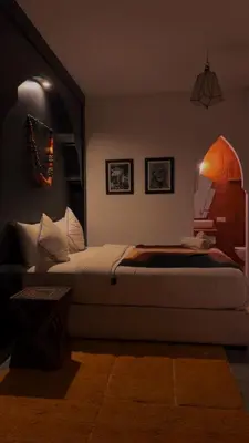 a bedroom with a bed and a table in a room at Riad SASHA Exclusive&New Pool 6 pax Free Breakfast in Marrakech