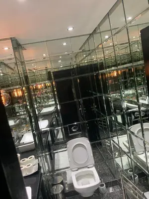 a bathroom with a toilet and sinks in a building at Residence marjane in Marrakech