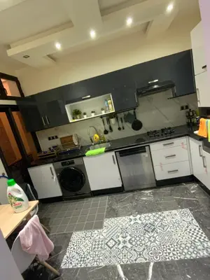 a kitchen with white cabinets and a stove top oven at Residence marjane in Marrakech