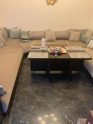a living room with a couch and a table with a candle at Residence marjane in Marrakech