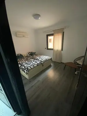 a bedroom with a bed and a window at Residence marjane in Marrakech