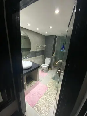 a bathroom with a sink and a toilet and a mirror at Residence marjane in Marrakech