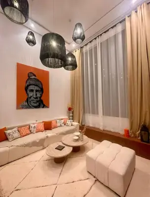 a living room with a couch and a table at Luxueux Duplex 3 chambres à Victor Hugo in Marrakech