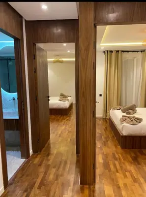 a room with two beds and a mirror at Luxueux Duplex 3 chambres à Victor Hugo in Marrakech