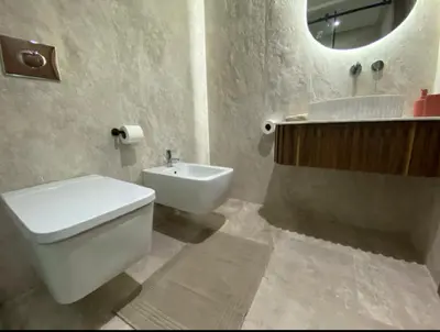 a bathroom with a toilet and a sink and a mirror at Luxueux Duplex 3 chambres à Victor Hugo in Marrakech