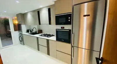 a kitchen with a stainless steel refrigerator at Luxueux Duplex 3 chambres à Victor Hugo in Marrakech