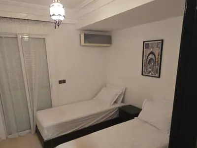 a small room with a bed and a window at Rita 83 in Marrakech