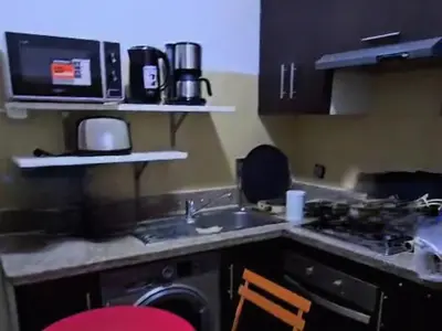 a kitchen with a sink and a washing machine at Rita 83 in Marrakech