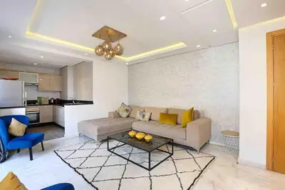 a living room with a couch and a table at Elegant and Modern appart hôtel with Best location in Marrakech