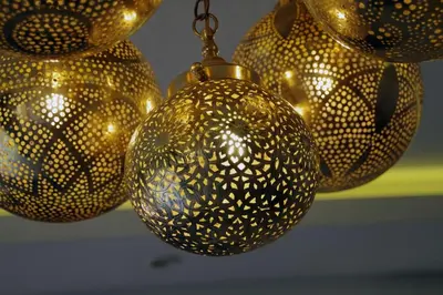 a group of gold balls hanging from a ceiling at Elegant and Modern appart hôtel with Best location in Marrakech