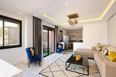 a living room with a couch and a table at Elegant and Modern appart hôtel with Best location in Marrakech